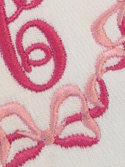 embroidered initial burp cloth with bows