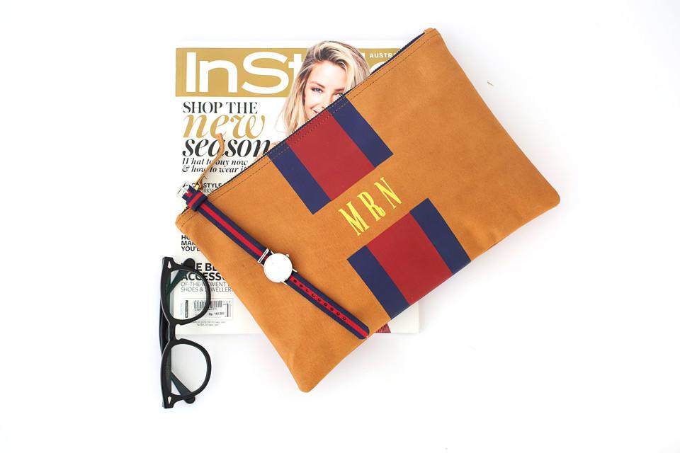 striped monogrammed leather flat clutch